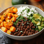 Ground beef cottage cheese bowl topped with avocado and hot honey